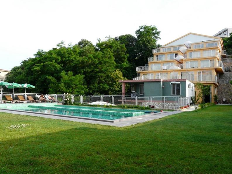 a hotel with a swimming pool next to a building at Apart Hotel Eden in Golden Sands