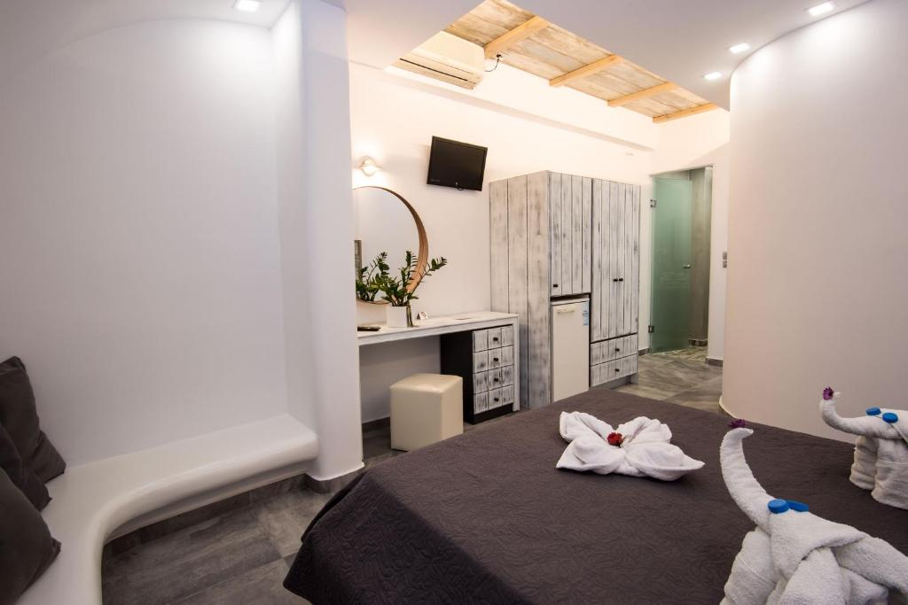 Postel nebo postele na pokoji v ubytování Gianna Suites