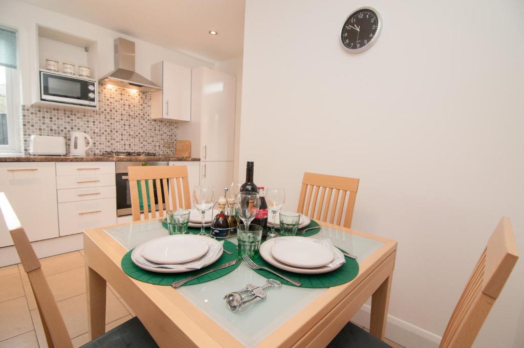 a dining room with a table with a bottle of wine at Warren House in Doncaster