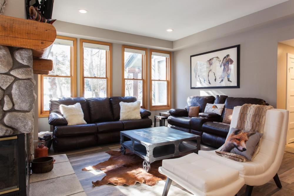a living room with leather furniture and a fireplace at Snowcreek #881 - Phase V in Mammoth Lakes