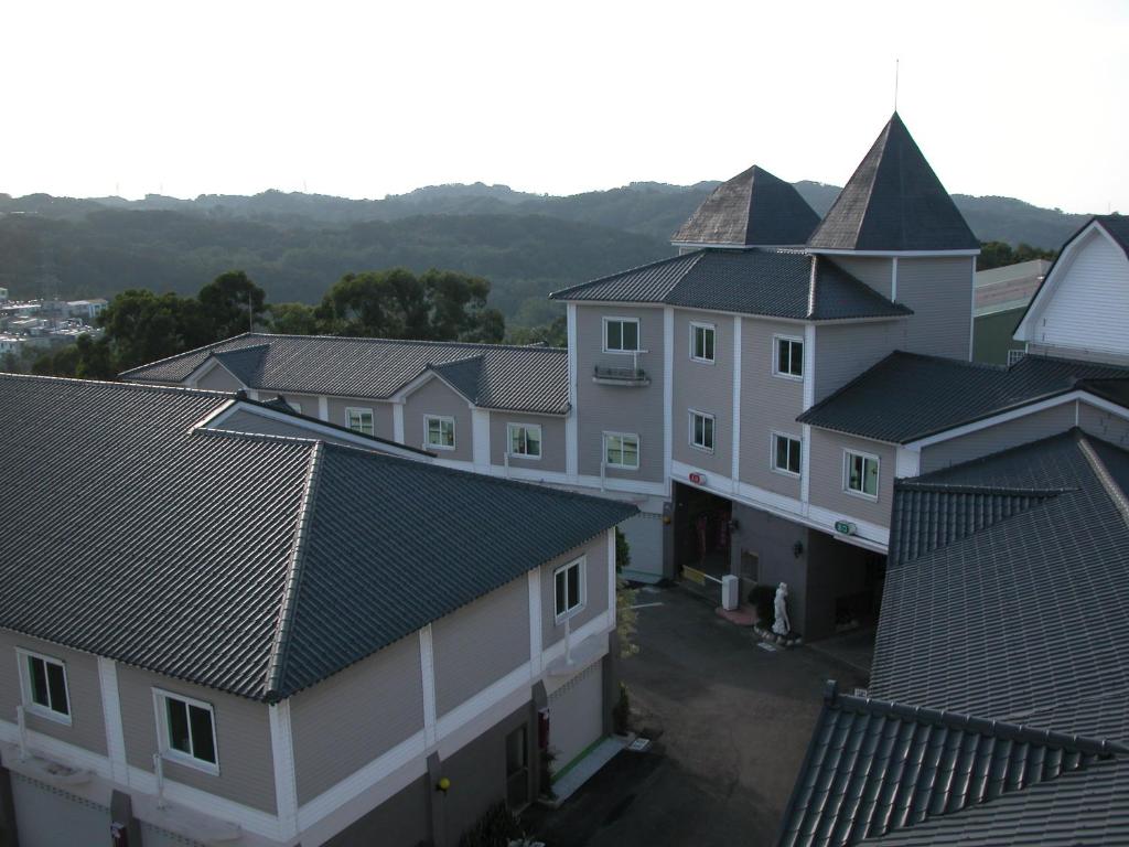 an aerial view of a row of houses with roofs at Milan Motel in Miaoli