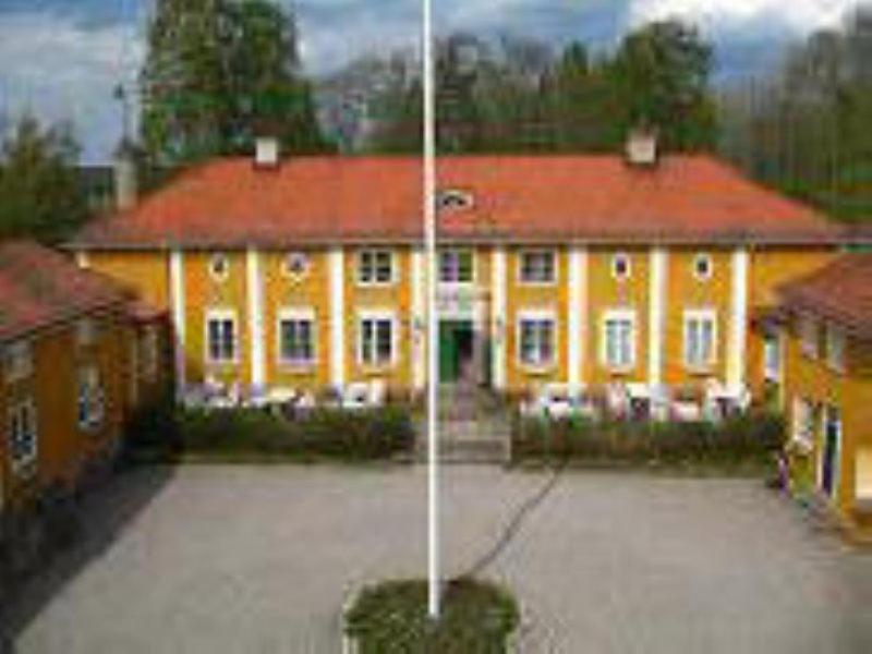 a large yellow building with a red roof at Forsbacka Wärdshus in Forsbacka