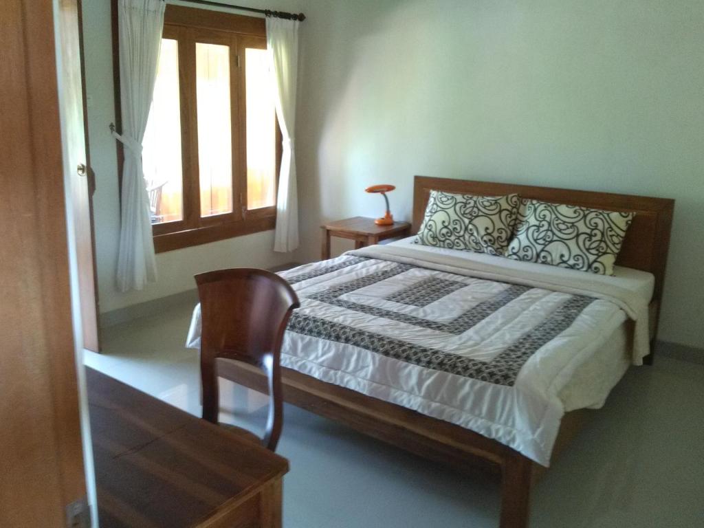 Postel nebo postele na pokoji v ubytování Indraprastha Ubud Home Stay