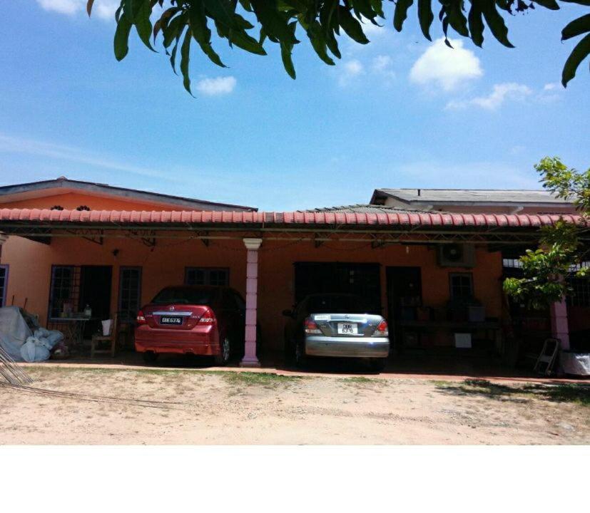 two cars parked in front of a house at My Friend Homestay in Kota Bharu