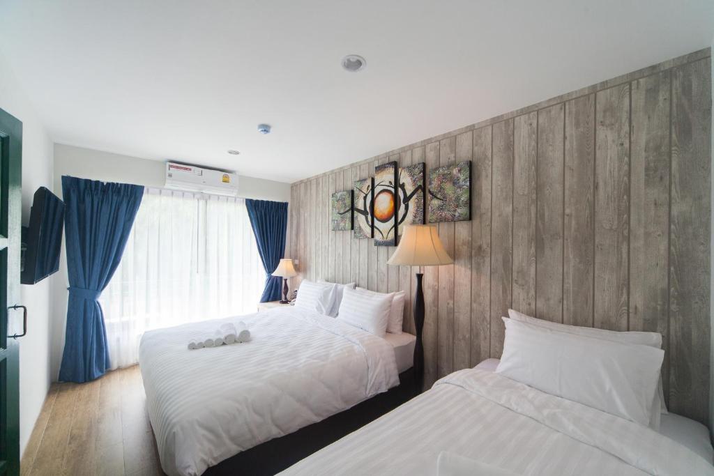 Säng eller sängar i ett rum på Anchan Laguna Hotel โรงแรมอัญชันลากูน่า