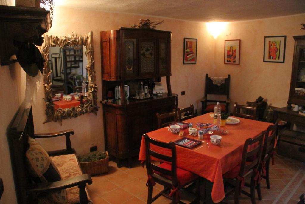 a dining room with a red table and chairs at Bed & Breakfast Triora Medievale in Triora