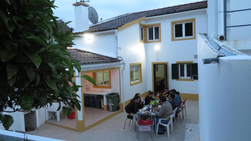 a group of people sitting at tables outside of a building at Casa Formosa in Furnas