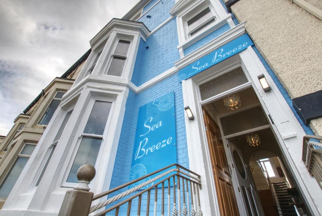 a blue building with a sign on it at Sea breeze in Whitby