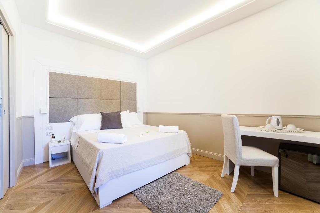 Łóżko lub łóżka w pokoju w obiekcie Margherita Suites