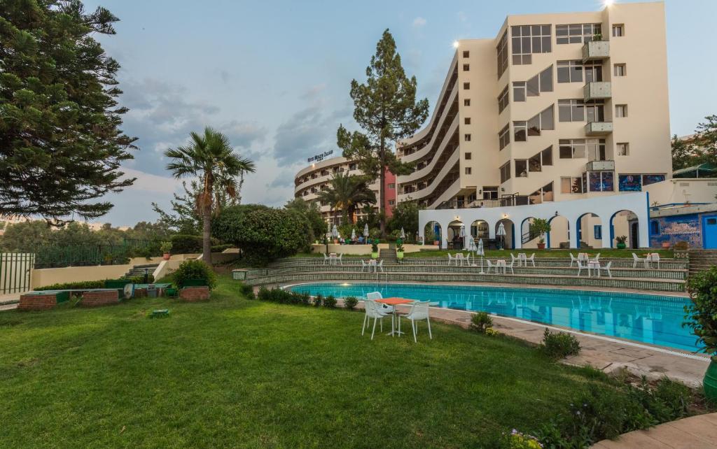 een resort met een zwembad en een gebouw bij Menzeh Zalagh City Center in Fès