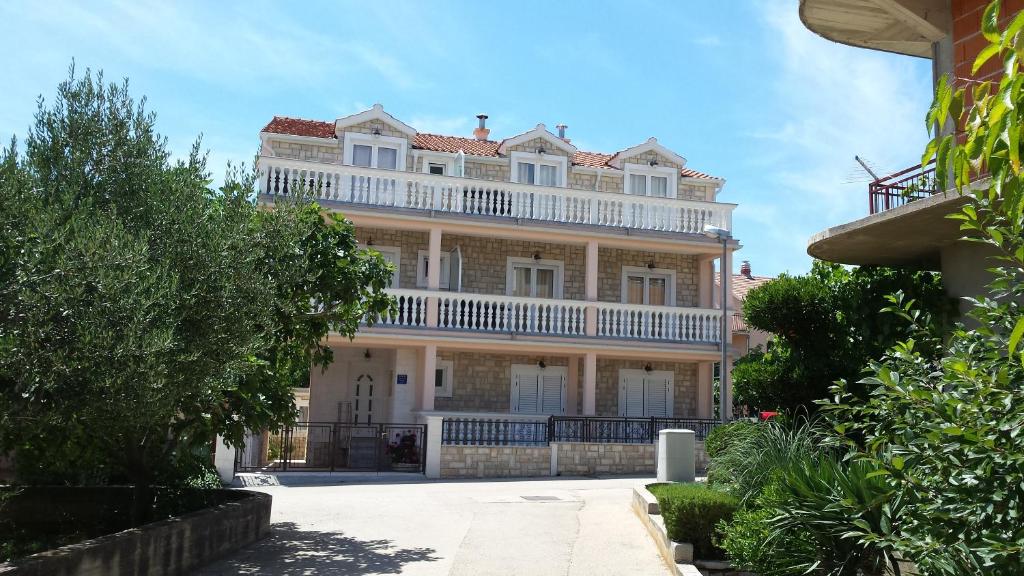 a large white house with a balcony on top of it at Guest House As in Vodice