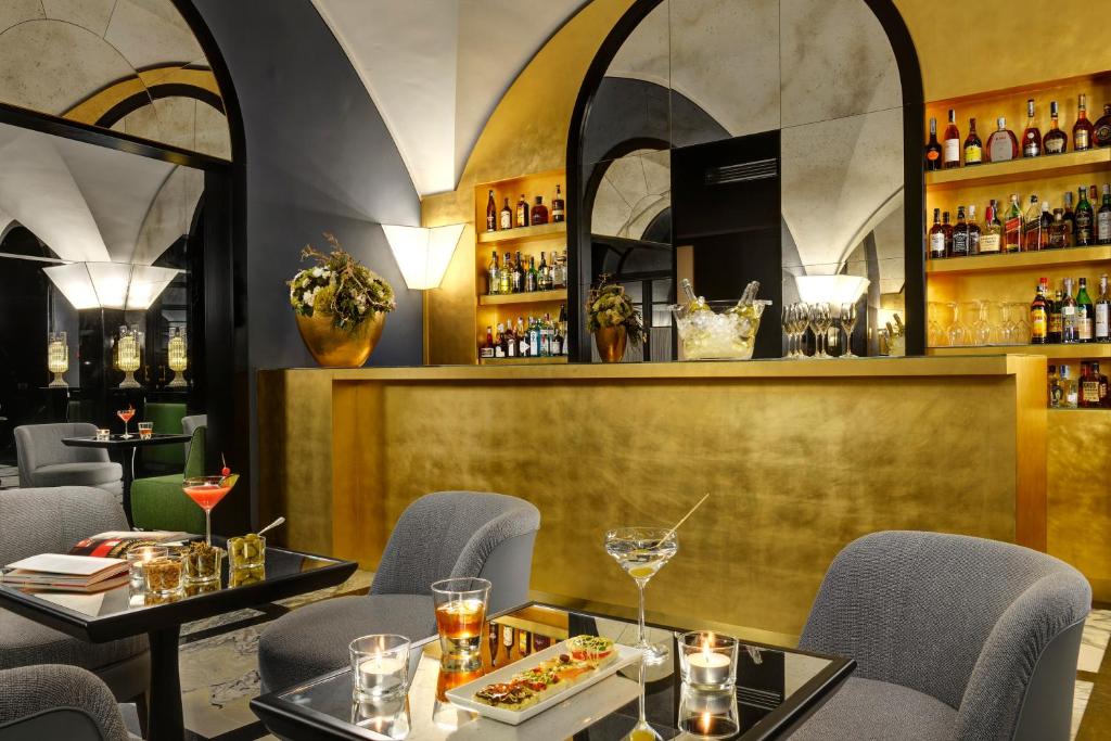 a restaurant with two tables and chairs and a bar at Hotel Balestri - WTB Hotels in Florence