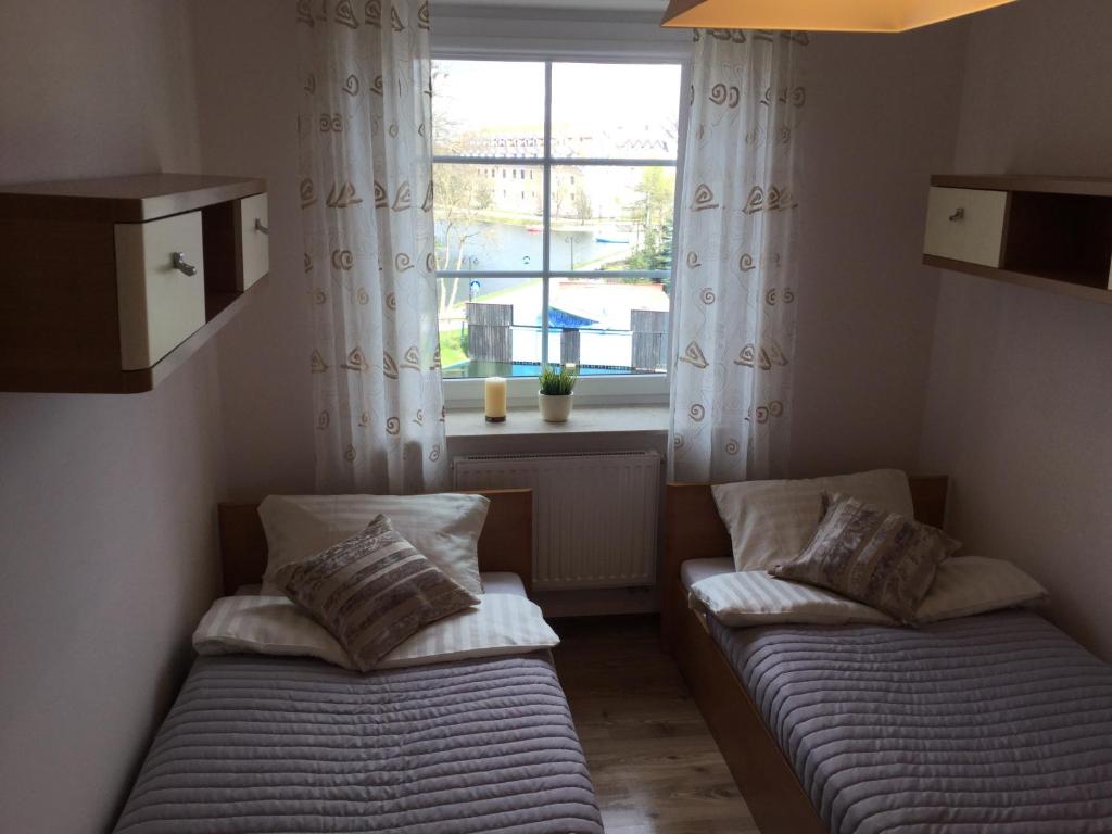 Posteľ alebo postele v izbe v ubytovaní Apartament VIP Vęgoria