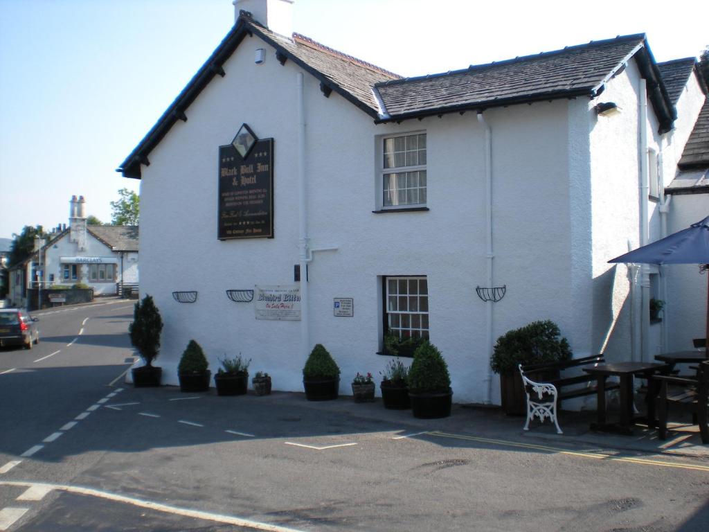 a white building with a sign on the side of it at The Black Bull Inn and Hotel in Coniston