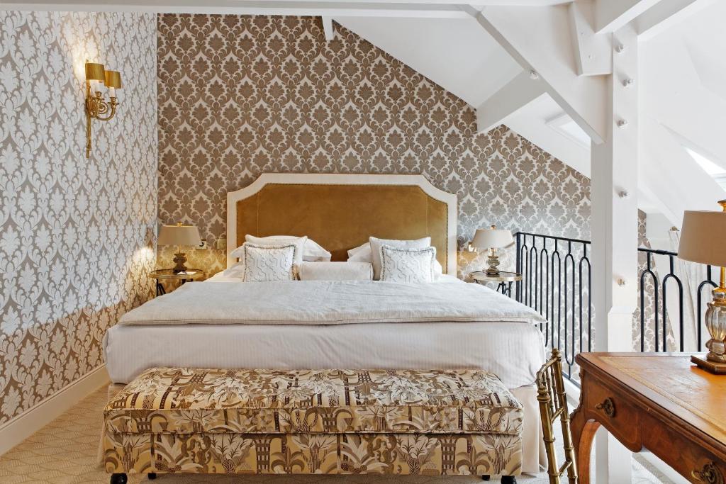 a bedroom with a large bed and a staircase at Relais Christine in Paris