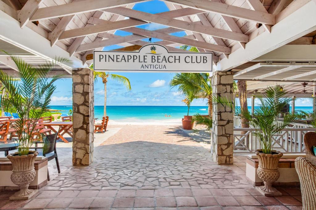
a beach with palm trees and palm trees at Pineapple Beach Club - All Inclusive Adult Only in Willikies
