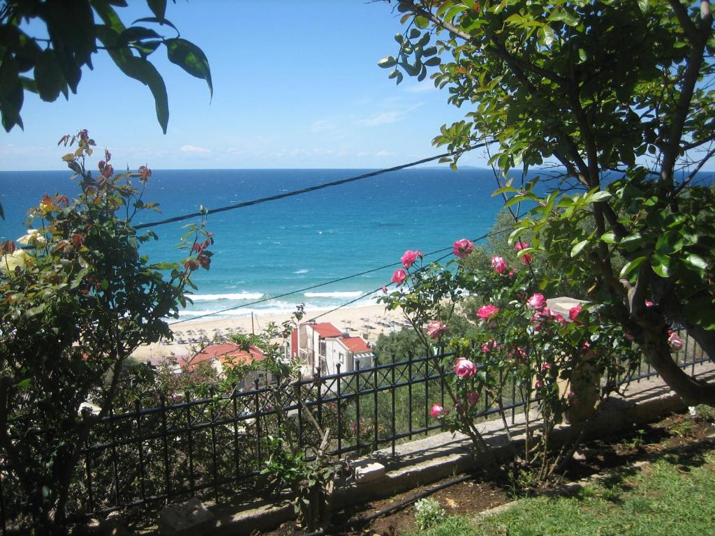 a view of the beach from a garden at Villa Sunset in Paralia Vrachou