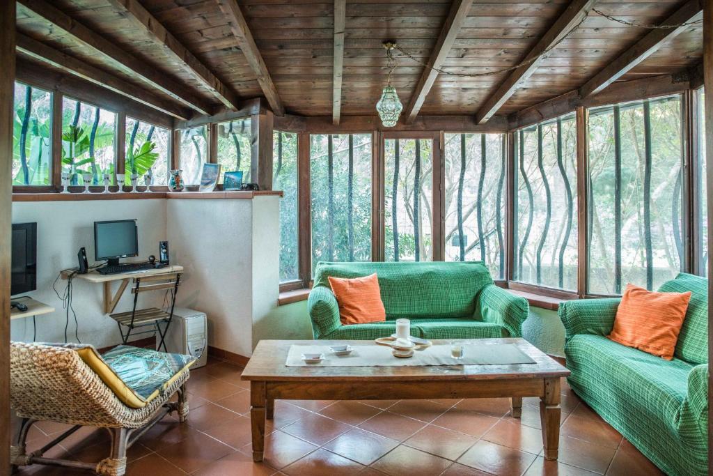 スフェッラカヴァッロにあるVilla Ancilo' al Mareのリビングルーム(緑のソファ、コーヒーテーブル付)