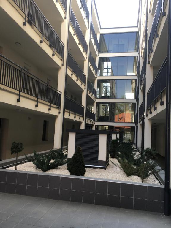 a large building with a courtyard with plants in it at Belle Casa 24 in Debrecen