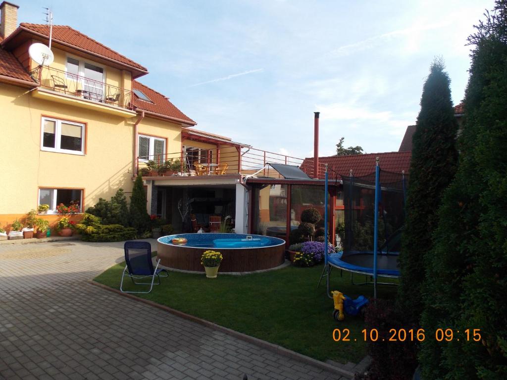 a backyard with a swimming pool and a house at Apartman JaS in Liptovský Mikuláš