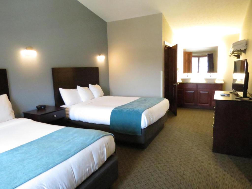 a hotel room with two beds and a television at Edgewater Hotel and Suites in Put-in-Bay