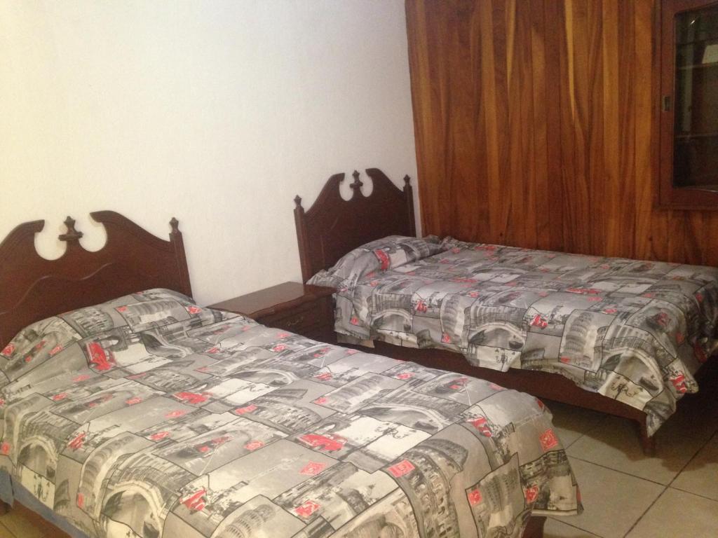 Postel nebo postele na pokoji v ubytování Hostal Makea Pachuca