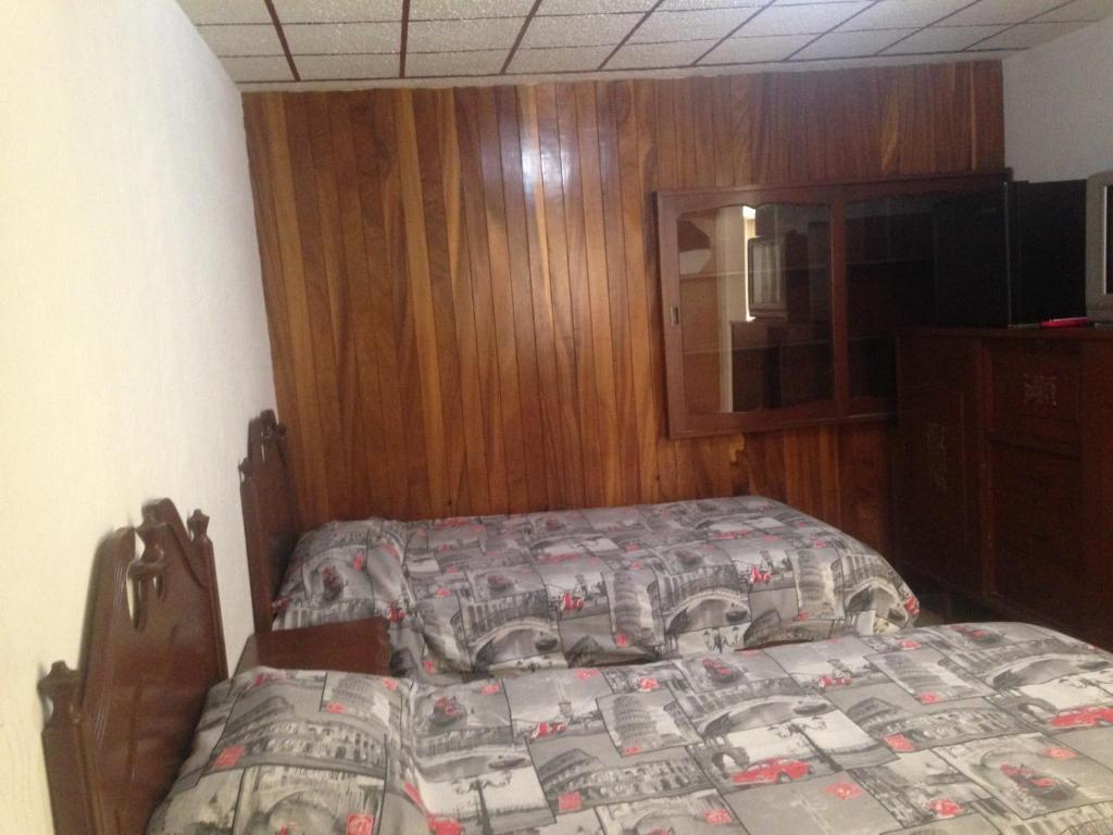 Postel nebo postele na pokoji v ubytování Hostal Makea Pachuca