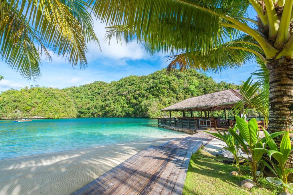 a beach with a pier and a gazebo at Sea Passion Hotel in Koror