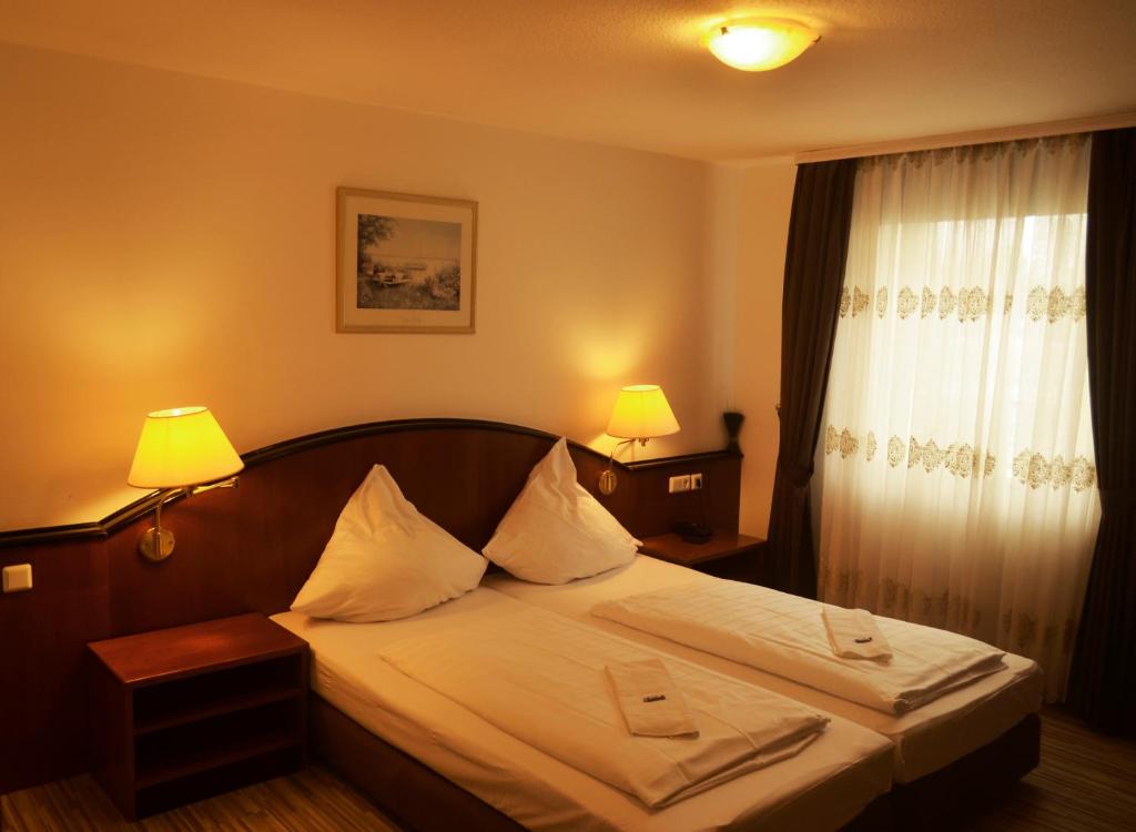 a bedroom with a bed with two towels on it at AS Hotel in Göttingen