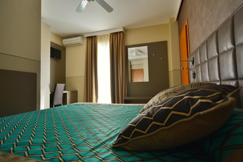 Postel nebo postele na pokoji v ubytování Hotel Sorriso
