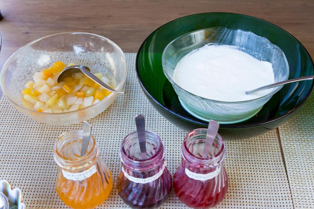 a bowl of milk and a bowl of fruit and other ingredients at Hotel Route-Inn Tokyo Ikebukuro in Tokyo