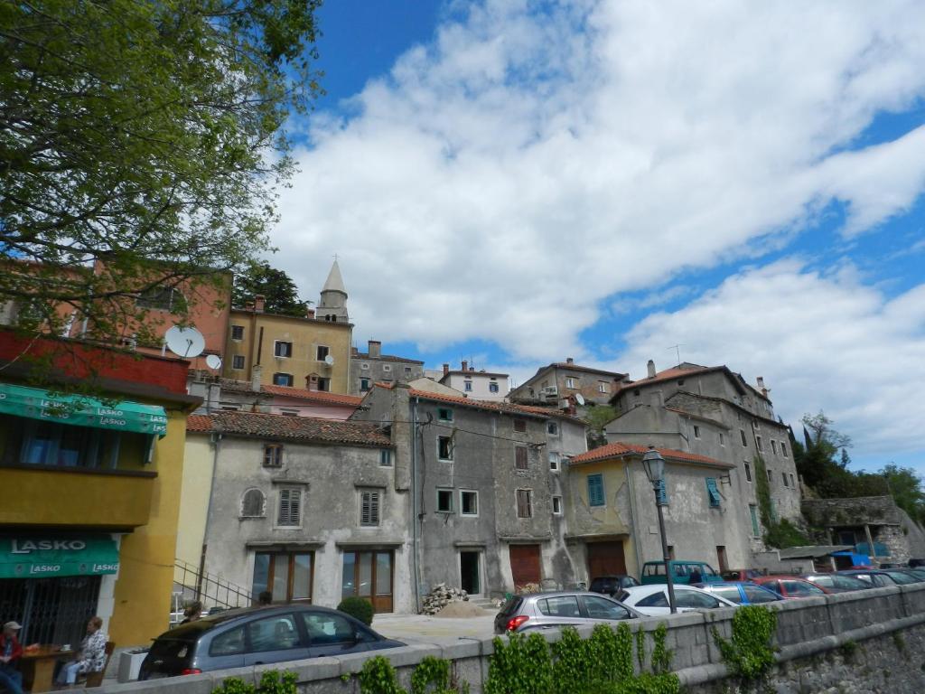 a group of buildings and cars on a street at Dee&#39;s House and Pool in Labin