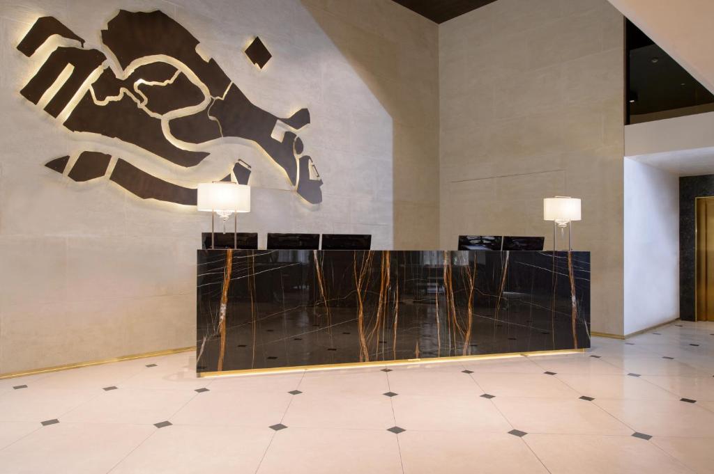 a lobby with a horse graphic on the wall at Palazzo Veneziano - Venice Collection in Venice