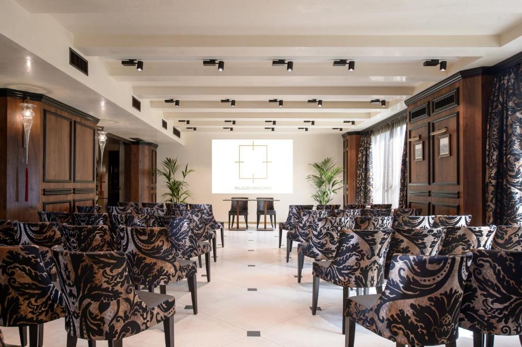 a room with rows of chairs in a room with a window at Palazzo Veneziano - Venice Collection in Venice