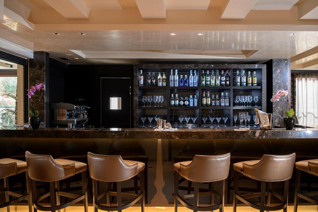 a bar in a restaurant with leather stools at Palazzo Veneziano - Venice Collection in Venice