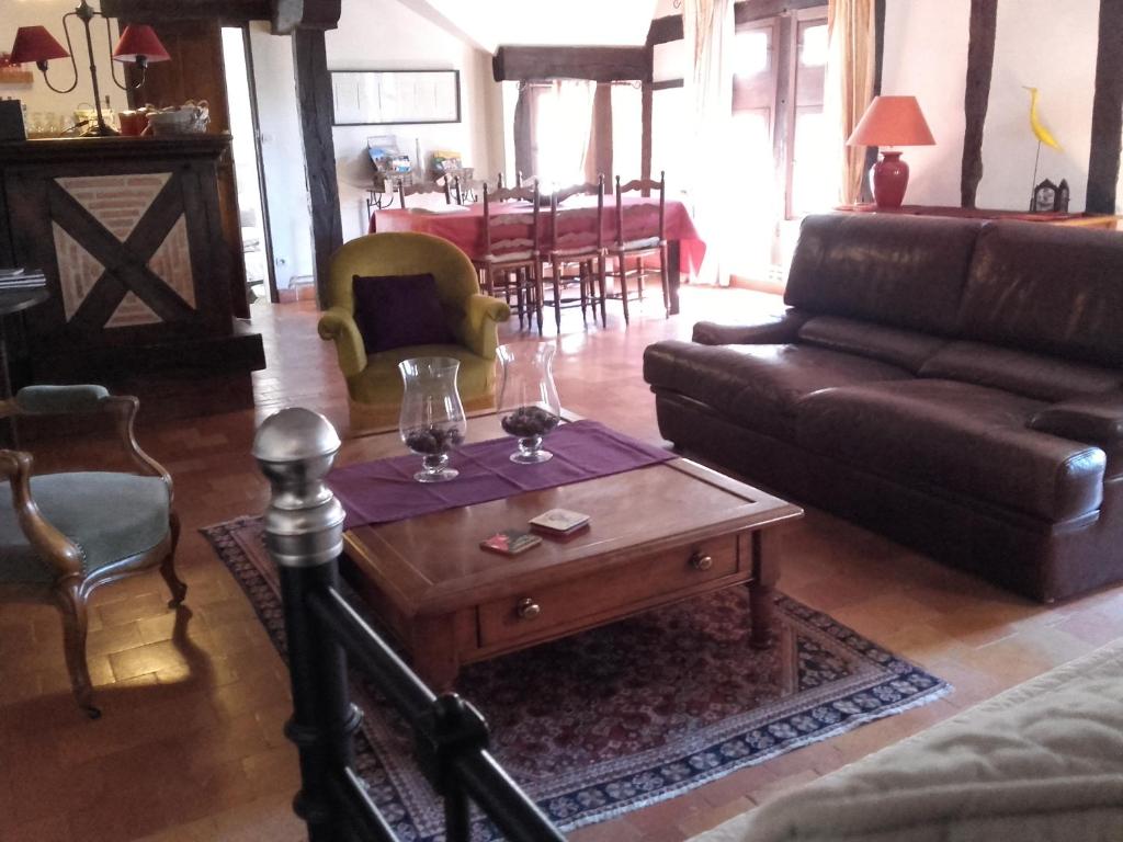 a living room with a couch and a coffee table at La Maison Rouge in Chinon