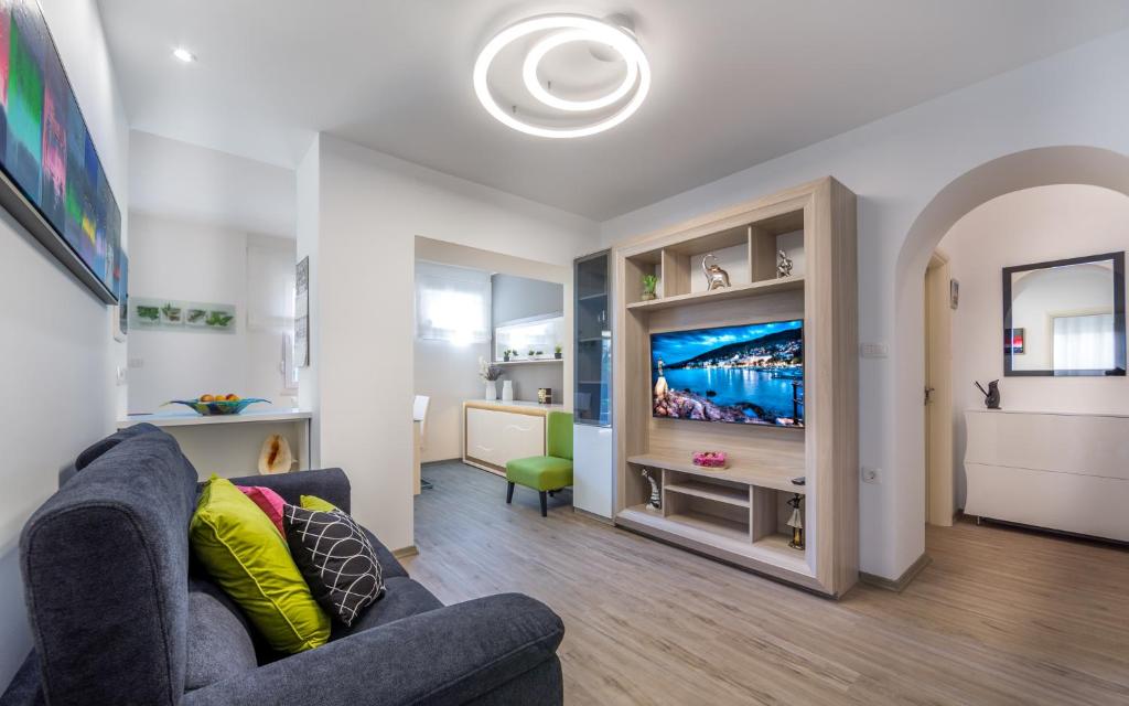 a living room with a couch and a tv at Apartments Dujmic - 50m from the sea with private parking in Ičići
