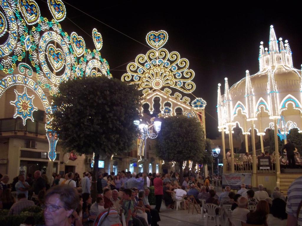 a crowd of people walking around a carnival at night at A Casa di Maria in Palagiano