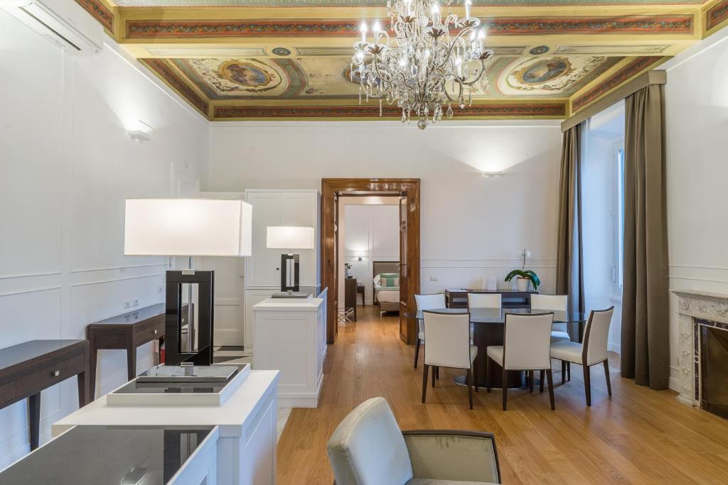 a dining room and living room with a chandelier at Internazionale Domus in Rome