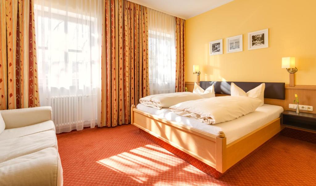 a hotel room with a bed and a window at Hotel Seehof in Herrsching am Ammersee