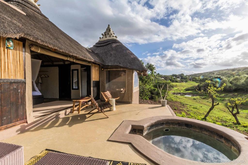 an outdoor patio of a house with a swimming pool at Safari Lodge - Amakhala Game Reserve in Amakhala Game Reserve