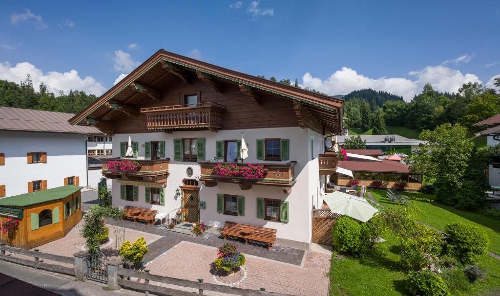 an aerial view of a house with benches at Landgasthof Dorfstadl in Kössen