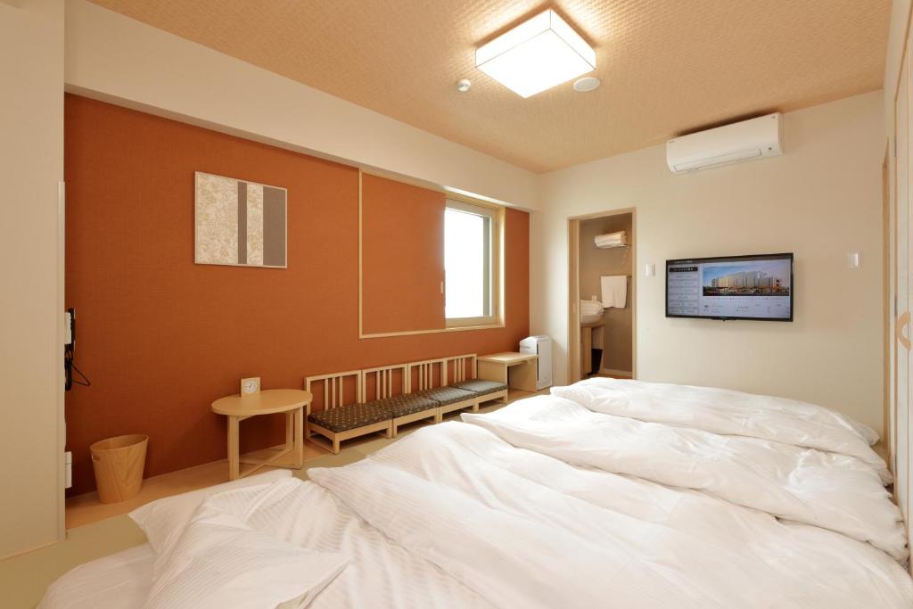 Postel nebo postele na pokoji v ubytování Hiyori Hotel Maihama