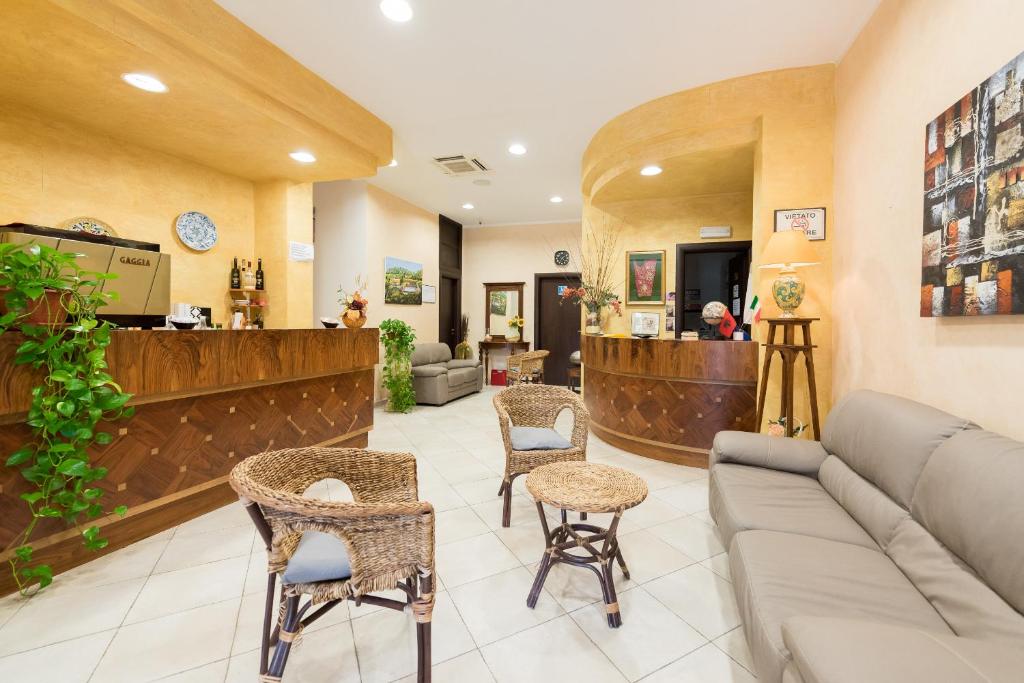 a lobby of a hospital with a couch and chairs at Valle Himara in Piana degli Albanesi