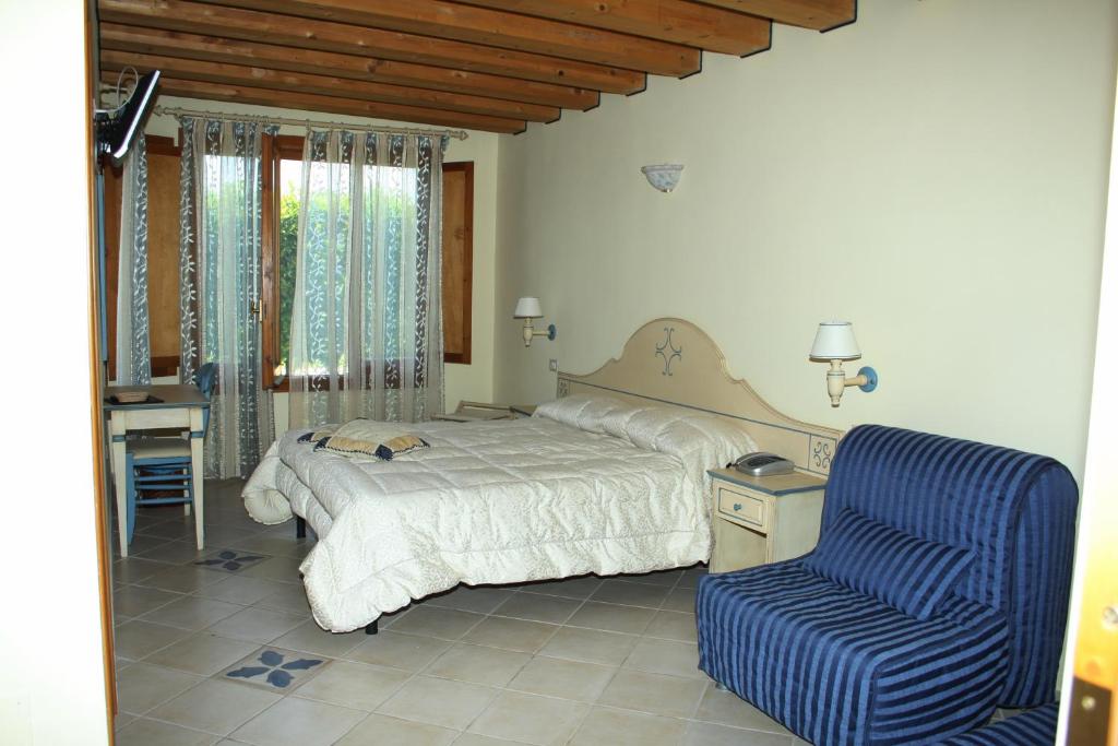 Postel nebo postele na pokoji v ubytování Hotel La Nave