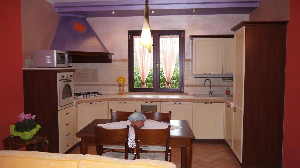 a kitchen with a table and chairs and a dining room at Cara Pace in Rimini