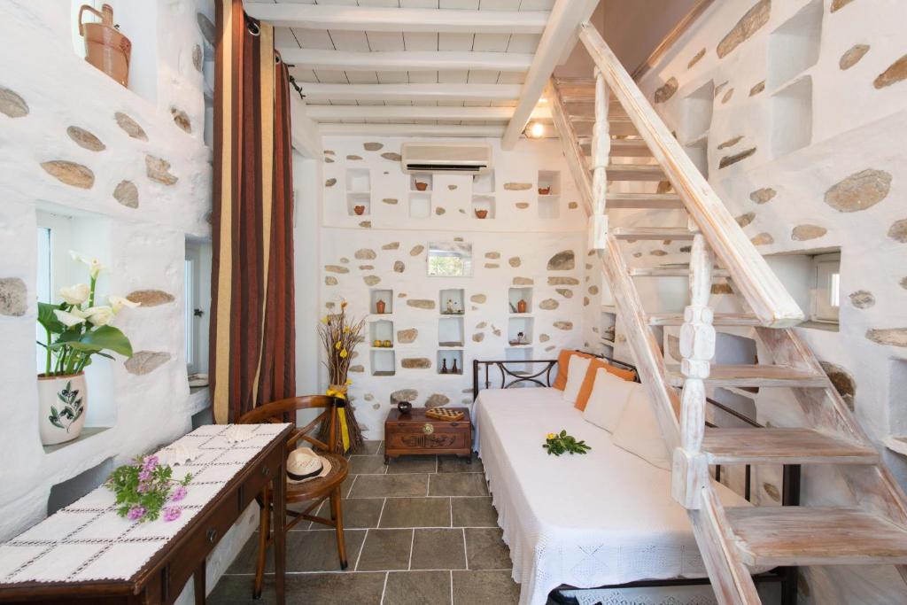 a room with a loft bed and a staircase at Peristeronas house sifnos - Dove Cot sifnos in Apollonia