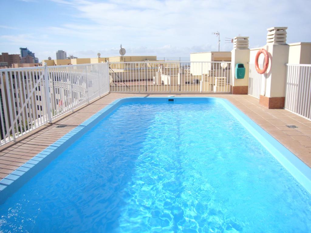 a swimming pool on the roof of a building at Gemelos 11 - Fincas Arena in Benidorm