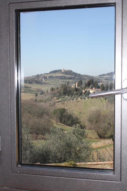 a window with a view of a field at Poderi in Chianti in Tavarnelle in Val di Pesa