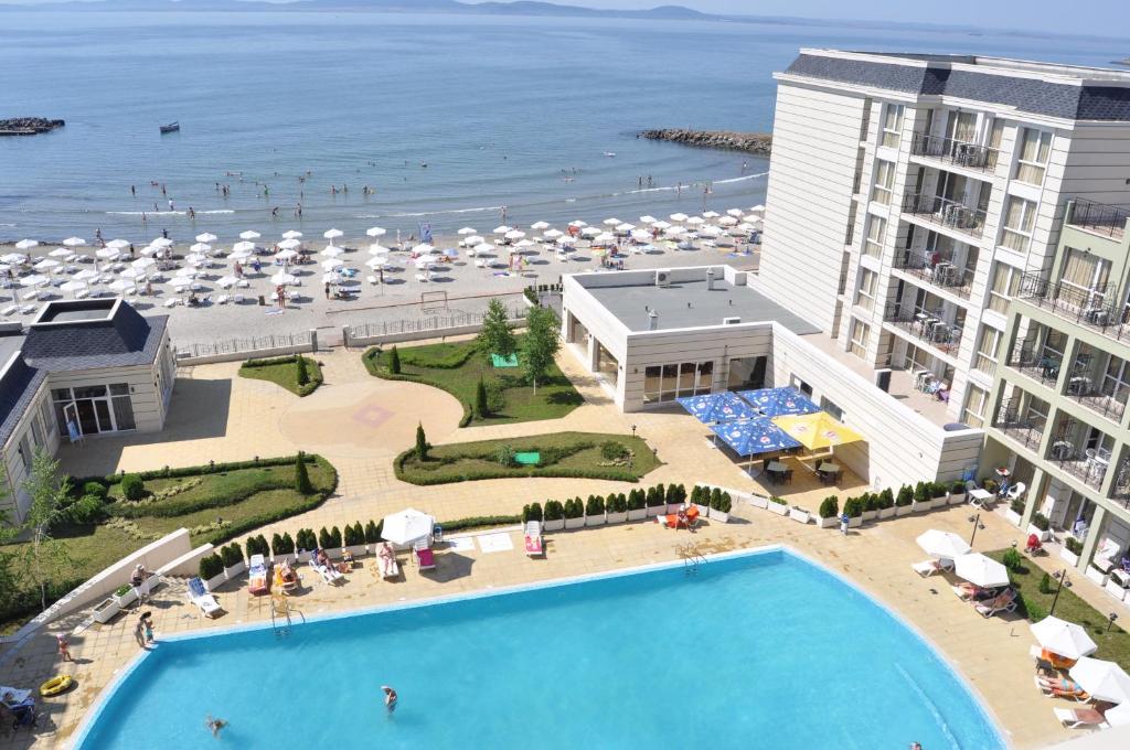 an aerial view of a resort with a pool and the beach at Private Studio 1st line in Pomorie